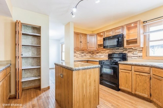 1029 Rain Tree Dr, Bolingbrook, IL 60440 - kitchen featuring black appliances, light wood-style floors, tasteful backsplash, rail lighting, and a kitchen island