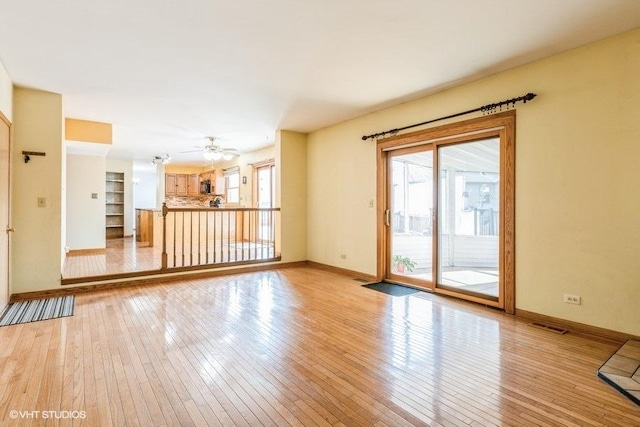 1029 Rain Tree Dr, Bolingbrook, IL 60440 - unfurnished living room featuring light wood-type flooring and ceiling fan
