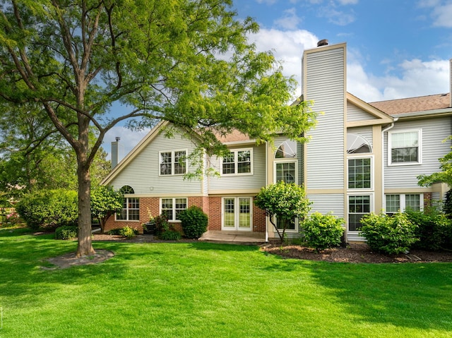 2349 County Farm Ln, Schaumburg, IL 60194 - back of house featuring a chimney, a lawn, and brick siding