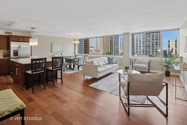 1 E Schiller St Unit 10B, Chicago, IL 60610 - living area featuring dark wood finished floors, a view of city, and baseboards