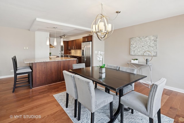 1 E Schiller St Unit 10B, Chicago, IL 60610 - dining space with a chandelier, light wood-style floors, and baseboards