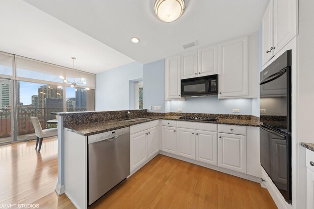 21 E Huron St Unit 1101, Chicago, IL 60611 - dining space with light wood-style flooring, expansive windows, a chandelier, baseboards, and a view of skyline