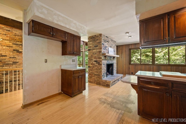 4N194 Thornly Rd, Saint Charles, IL 60174 - kitchen featuring light wood finished floors, light countertops, a fireplace, dark brown cabinetry, and open floor plan