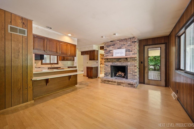 4N194 Thornly Rd, Saint Charles, IL 60174 - kitchen with wood walls, light wood finished floors, open floor plan, a breakfast bar, and a peninsula