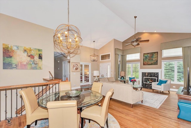 20400 Mackinac Point Dr, Frankfort, IL 60423 - dining area featuring high vaulted ceiling, wood finished floors, a ceiling fan, a premium fireplace, and a chandelier