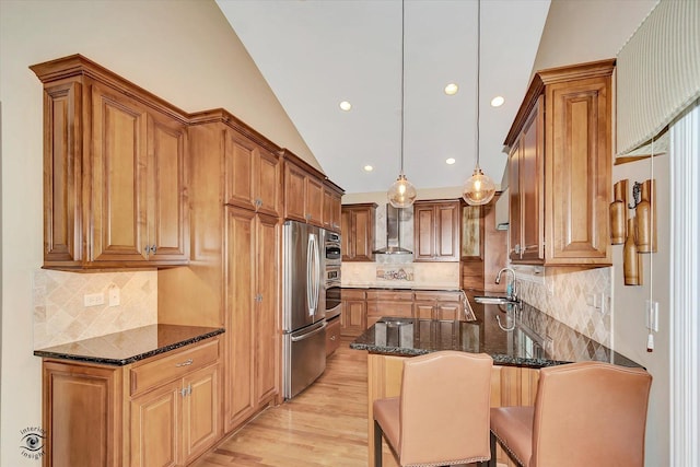 20400 Mackinac Point Dr, Frankfort, IL 60423 - kitchen featuring appliances with stainless steel finishes, wall chimney range hood, vaulted ceiling, dark stone countertops, and brown cabinetry