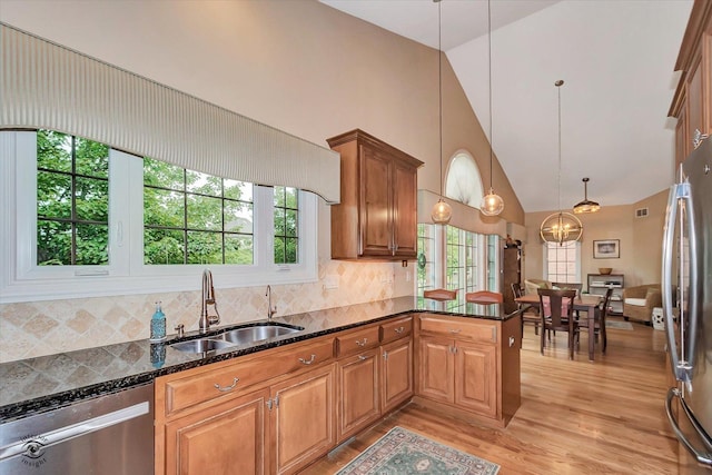 20400 Mackinac Point Dr, Frankfort, IL 60423 - kitchen featuring appliances with stainless steel finishes, high vaulted ceiling, light wood-style floors, brown cabinets, and a peninsula