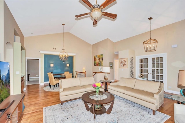 20400 Mackinac Point Dr, Frankfort, IL 60423 - living area with a chandelier, high vaulted ceiling, light wood-style flooring, ceiling fan, and french doors