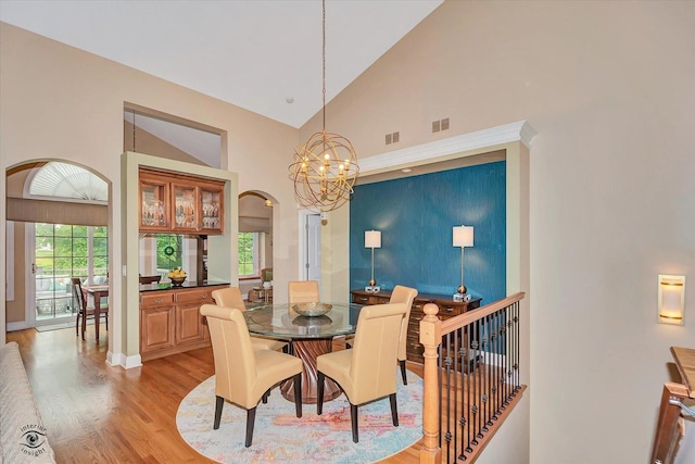 20400 Mackinac Point Dr, Frankfort, IL 60423 - dining room with light wood finished floors, arched walkways, a chandelier, and high vaulted ceiling