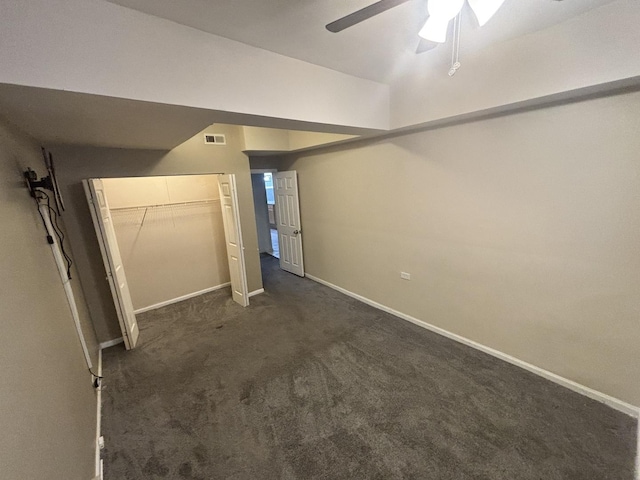 1430 E 69th St Unit 1S, Chicago, IL 60637 - unfurnished bedroom with baseboards, dark carpet, a closet, and a ceiling fan