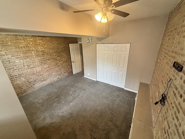 1430 E 69th St Unit 1S, Chicago, IL 60637 - unfurnished bedroom with carpet flooring, brick wall, a closet, a ceiling fan, and baseboards