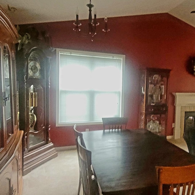 626 Sedgegrass Dr, Champaign, IL 61822 - dining area featuring a tiled fireplace, carpet floors, and vaulted ceiling