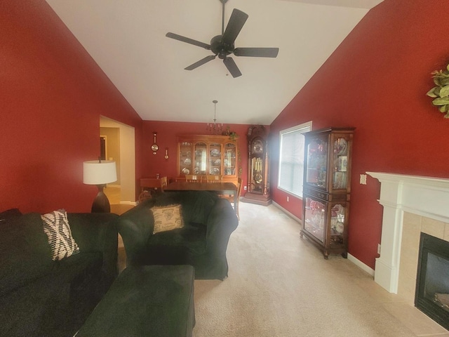 626 Sedgegrass Dr, Champaign, IL 61822 - living area with vaulted ceiling, a tile fireplace, ceiling fan, light colored carpet, and baseboards
