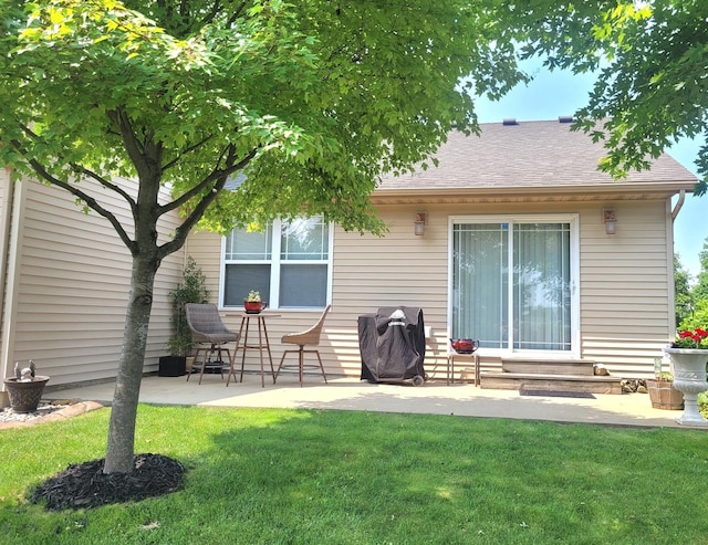 626 Sedgegrass Dr, Champaign, IL 61822 - back of house with entry steps, a yard, a shingled roof, and a patio area