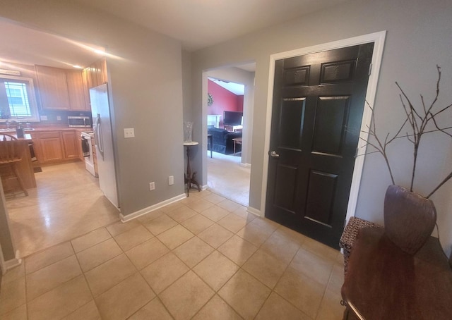 626 Sedgegrass Dr, Champaign, IL 61822 - kitchen with white appliances, light tile patterned flooring, a sink, light countertops, and baseboards