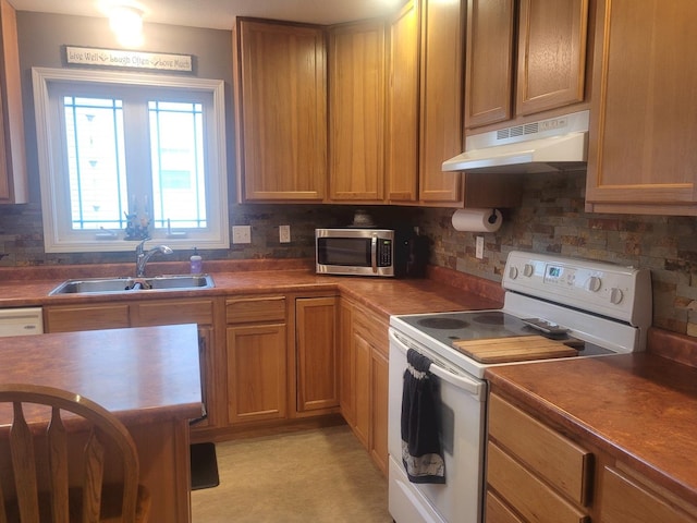 626 Sedgegrass Dr, Champaign, IL 61822 - kitchen featuring under cabinet range hood, electric range, a sink, stainless steel microwave, and decorative backsplash