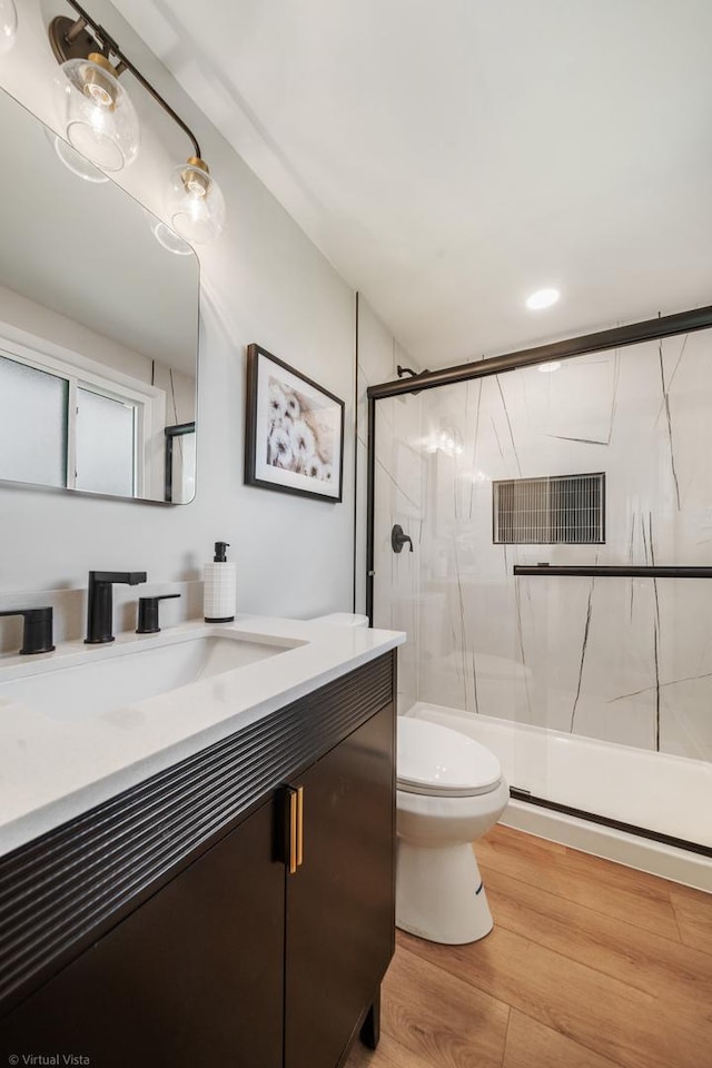 21W040 Monticello Rd, Lombard, IL 60148 - bathroom featuring toilet, vanity, a shower with shower door, and wood finished floors