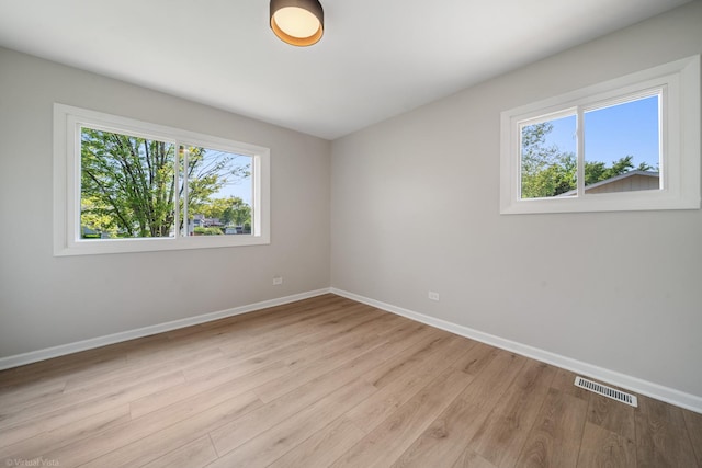 21W040 Monticello Rd, Lombard, IL 60148 - empty room with plenty of natural light, baseboards, and wood finished floors