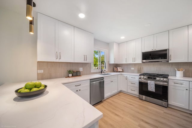 21W040 Monticello Rd, Lombard, IL 60148 - kitchen with appliances with stainless steel finishes, a sink, white cabinetry, tasteful backsplash, and recessed lighting