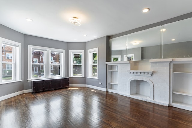 unfurnished living room featuring baseboards, radiator, wood finished floors, built in features, and recessed lighting
