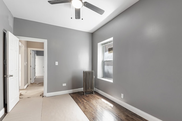spare room with radiator heating unit, baseboards, and ceiling fan