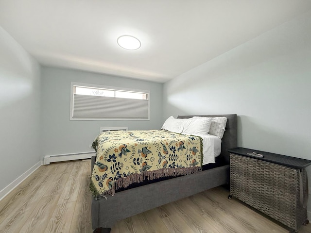 120 Collen Dr Unit 219, Lombard, IL 60148 - bedroom featuring a baseboard radiator, light wood-type flooring, and baseboards