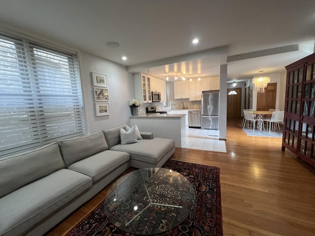 2125 N Clark St Unit 3, Chicago, IL 60614 - living room with a chandelier, light wood-type flooring, rail lighting, and recessed lighting