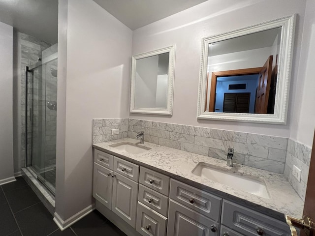 2125 N Clark St Unit 3, Chicago, IL 60614 - bathroom featuring double vanity, tile patterned flooring, a stall shower, and baseboards