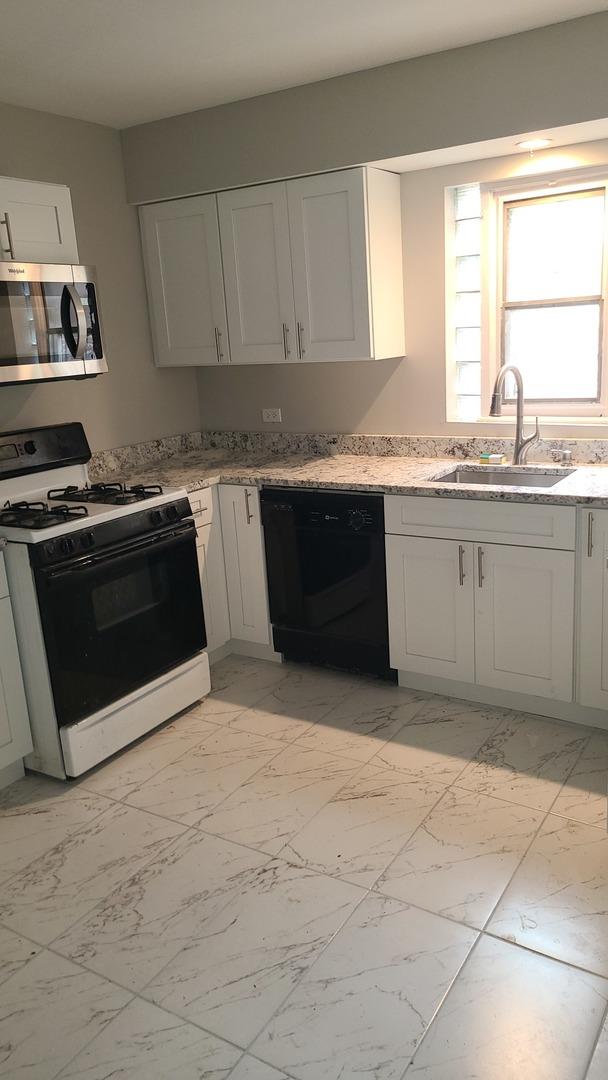 8214 S Yates Blvd, Chicago, IL 60617 - kitchen featuring range with gas cooktop, stainless steel microwave, black dishwasher, a sink, and light marble finish floors