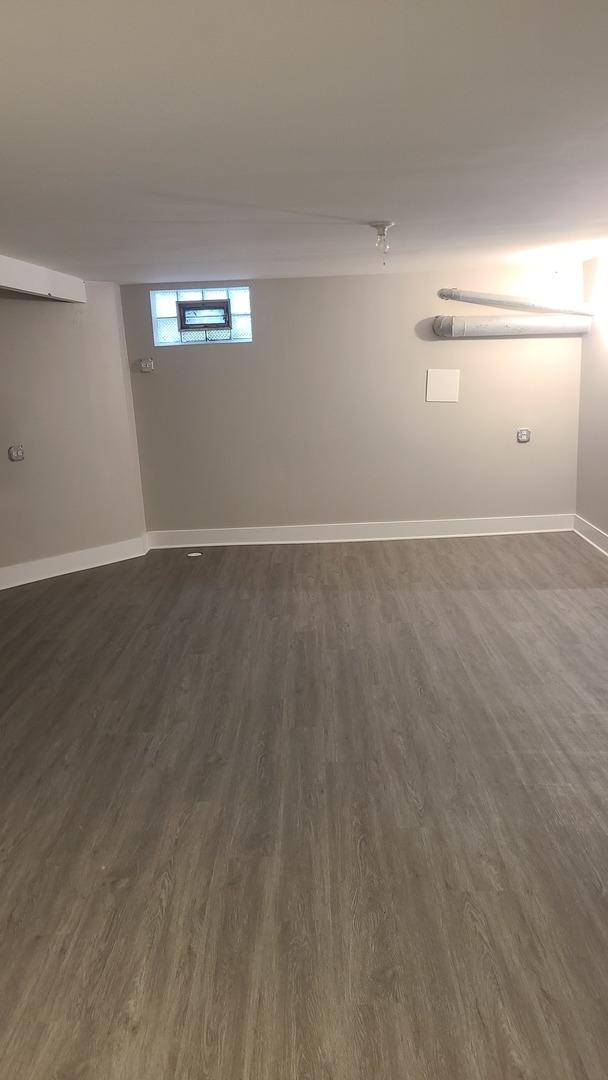 8214 S Yates Blvd, Chicago, IL 60617 - unfurnished room with dark wood finished floors and baseboards