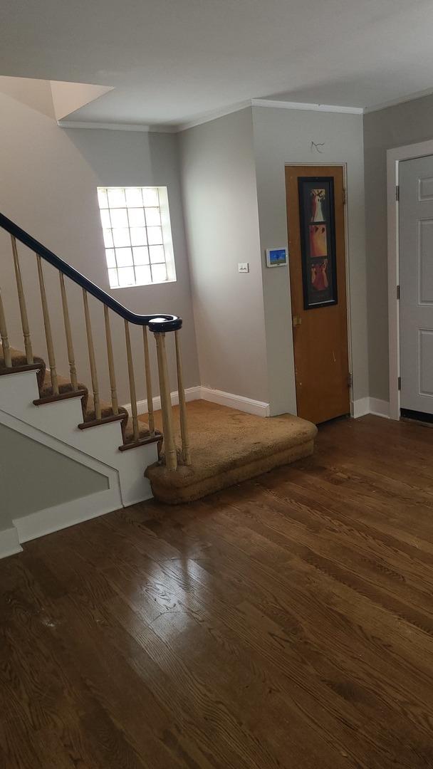 8214 S Yates Blvd, Chicago, IL 60617 - stairs featuring wood finished floors, crown molding, and baseboards