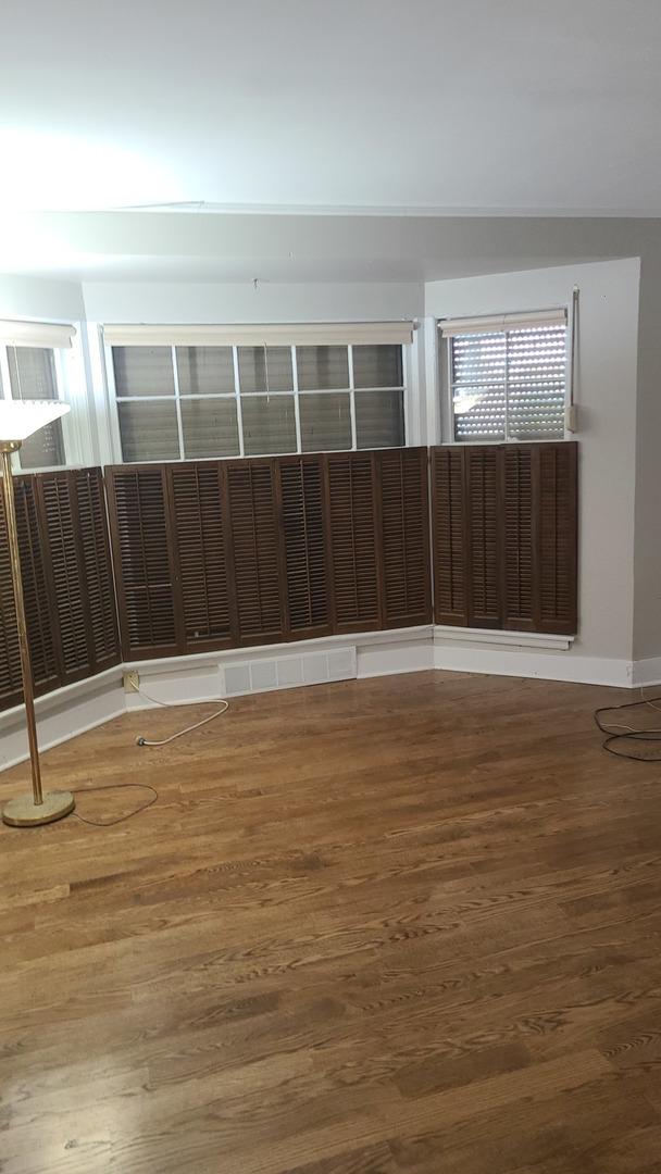 8214 S Yates Blvd, Chicago, IL 60617 - empty room featuring wood finished floors