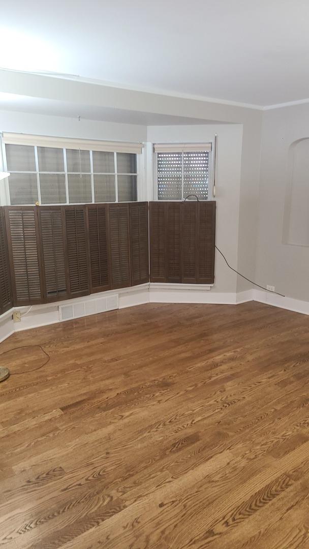 8214 S Yates Blvd, Chicago, IL 60617 - unfurnished room featuring wood finished floors, baseboards, and crown molding