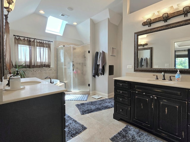18545 S Marilynn Ct, Mokena, IL 60448 - bathroom featuring a skylight, two vanities, a stall shower, tile patterned flooring, and lofted ceiling