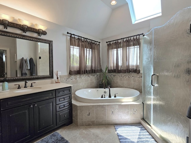 18545 S Marilynn Ct, Mokena, IL 60448 - bathroom featuring vanity, lofted ceiling, a bath, a skylight, and tile patterned floors