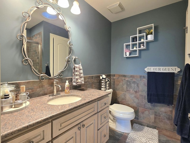 18545 S Marilynn Ct, Mokena, IL 60448 - full bath with vanity, toilet, a shower with door, tile walls, and a wainscoted wall
