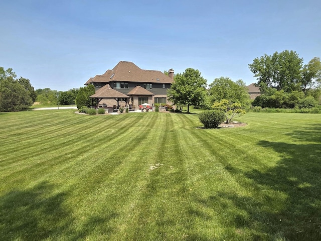 18545 S Marilynn Ct, Mokena, IL 60448 - back of house with a gazebo, a lawn, and a chimney