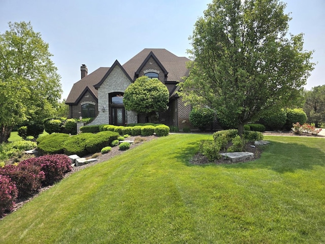 18545 S Marilynn Ct, Mokena, IL 60448 - french country home with stone siding, a front lawn, and a chimney