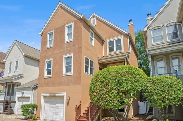 1800 W Diversey Pkwy Unit F, Chicago, IL 60614 - view of front facade with a garage, stucco siding, and stairs