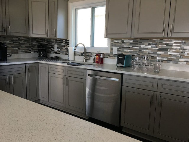 95 Manhattan Dr, Streator, IL 61364 - kitchen with dishwasher, a sink, gray cabinets, and tasteful backsplash