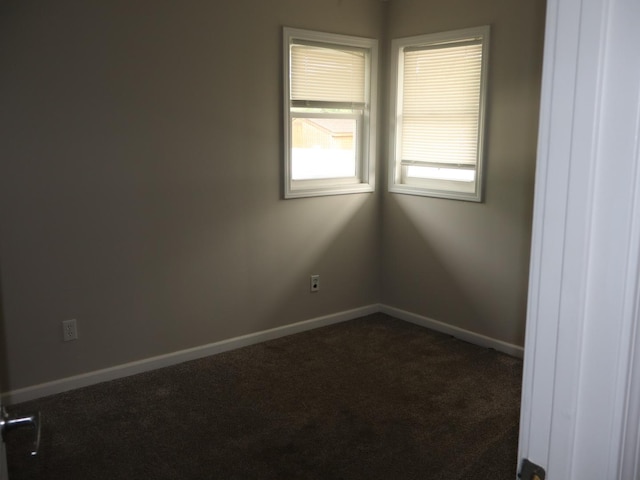 95 Manhattan Dr, Streator, IL 61364 - empty room with dark carpet and baseboards