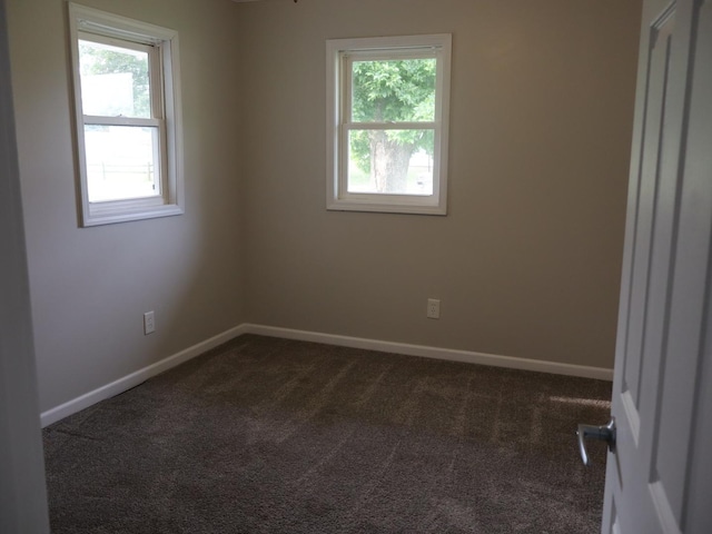95 Manhattan Dr, Streator, IL 61364 - unfurnished room with dark colored carpet and baseboards
