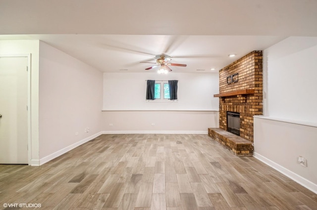 6407 Hillcrest Rd, Cary, IL 60013 - unfurnished living room featuring a ceiling fan, a brick fireplace, light wood-type flooring, and baseboards