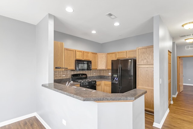 2215 Aurora Dr Unit 1, Pingree Grove, IL 60140 - kitchen with black appliances, baseboards, light brown cabinets, backsplash, and a peninsula