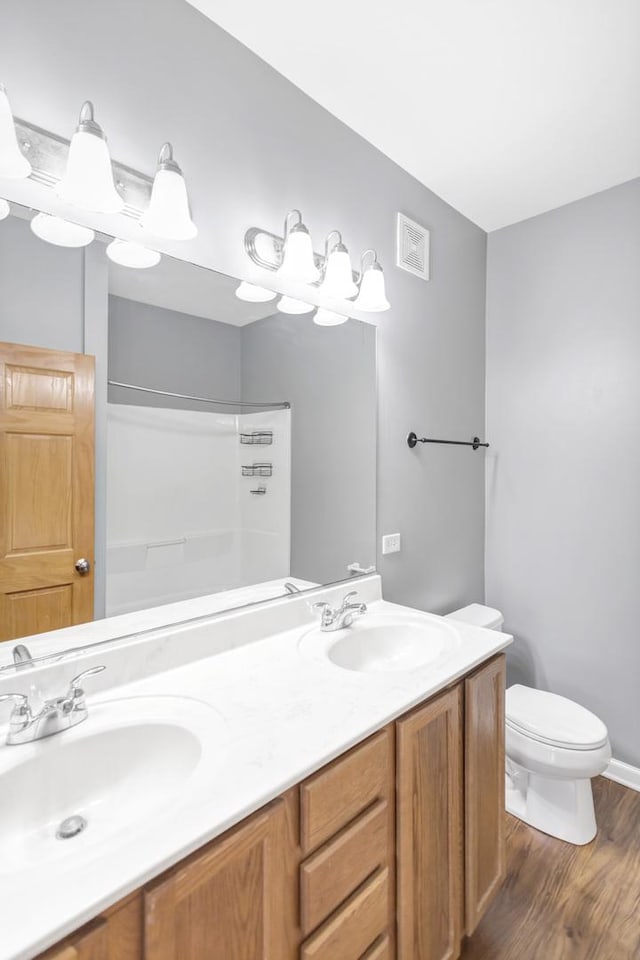 2215 Aurora Dr Unit 1, Pingree Grove, IL 60140 - full bath with double vanity, a shower, toilet, wood finished floors, and baseboards