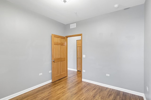 2215 Aurora Dr Unit 1, Pingree Grove, IL 60140 - unfurnished room with wood finished floors, baseboards, and a smoke detector