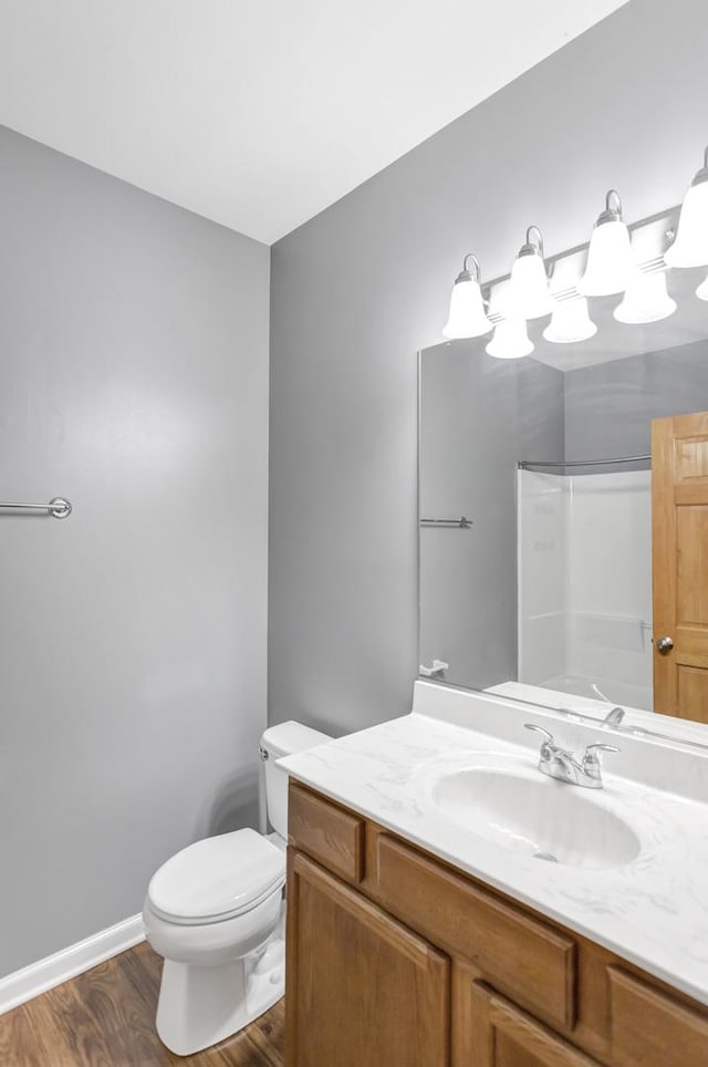 2215 Aurora Dr Unit 1, Pingree Grove, IL 60140 - bathroom with vanity, wood finished floors, toilet, baseboards, and a shower