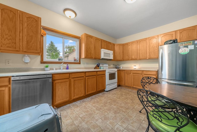 620 S Main St, Belvidere, IL 61008 - kitchen with appliances with stainless steel finishes, a sink, light countertops, and stone finish floors