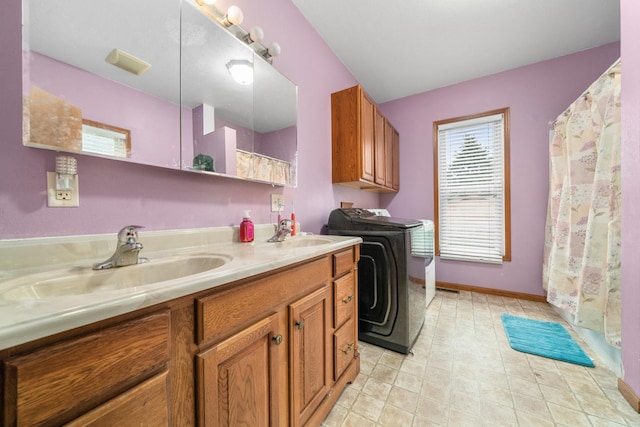 620 S Main St, Belvidere, IL 61008 - washroom featuring washer and dryer, baseboards, and cabinet space