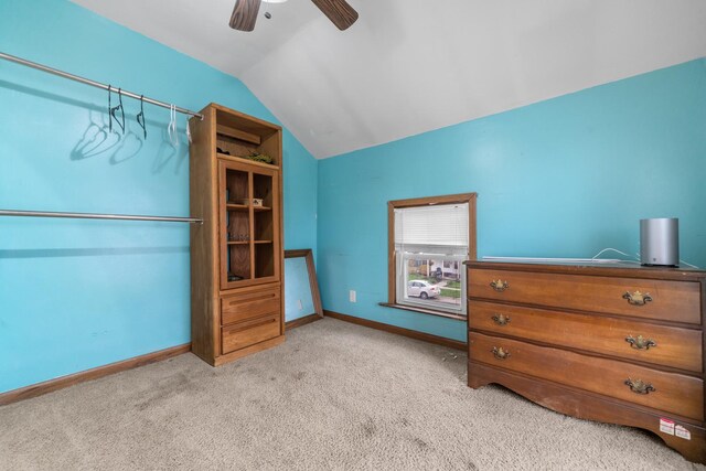 620 S Main St, Belvidere, IL 61008 - bedroom with light colored carpet, vaulted ceiling, baseboards, and ceiling fan